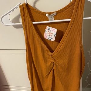 Cropped orange fitted top.